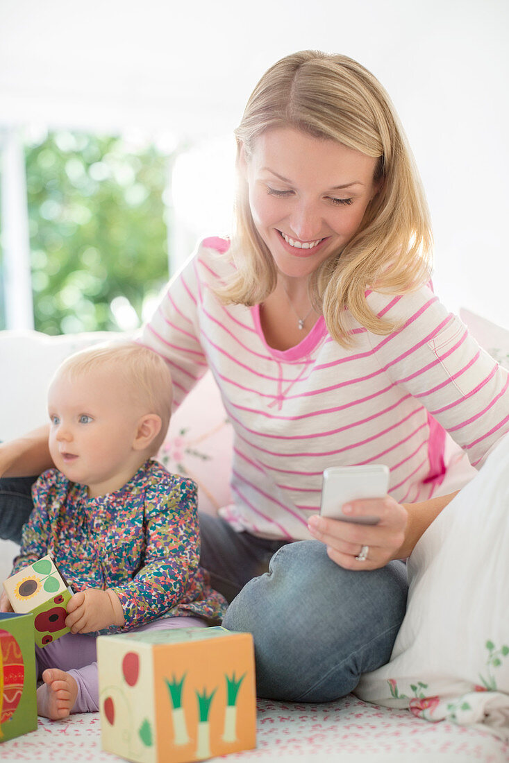 Mother playing with baby girl