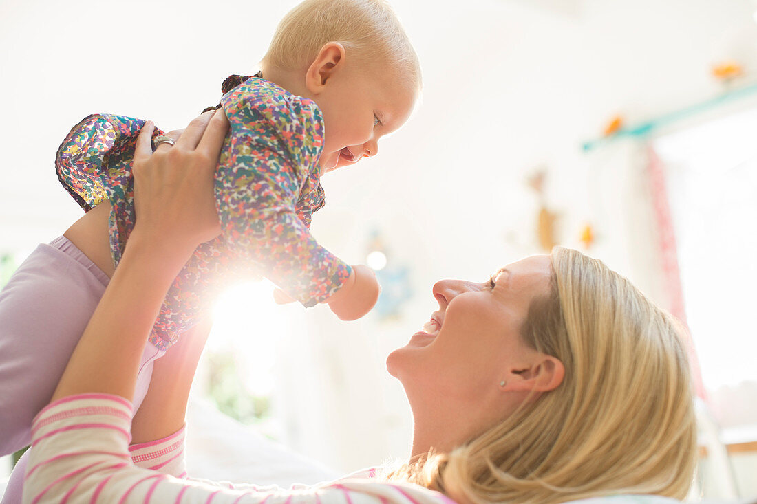 Mother playing with baby girl