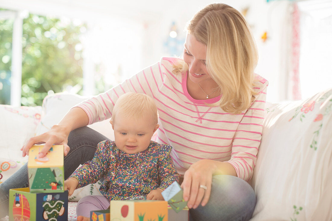 Mother and baby girl playing with blocks