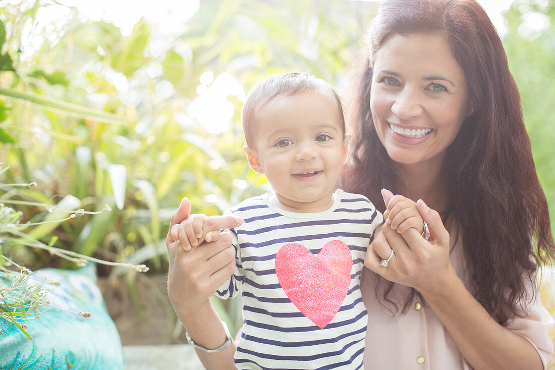 Mother holding daughter outdoors