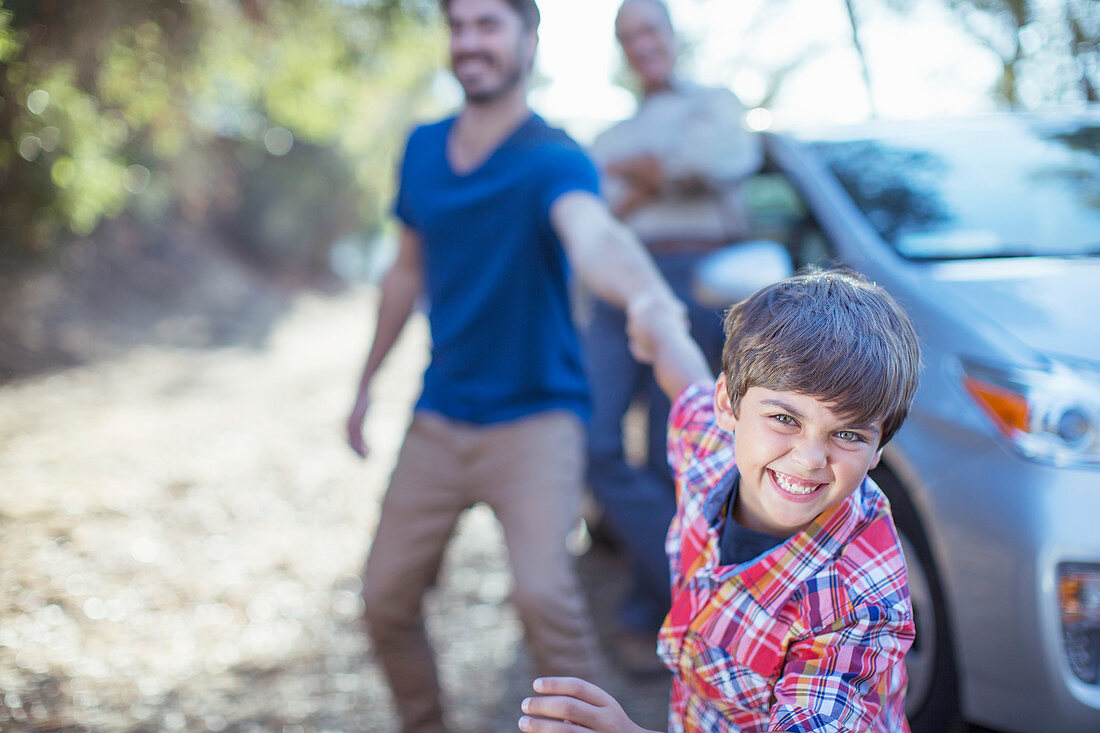 Happy boy dragging father by the arm