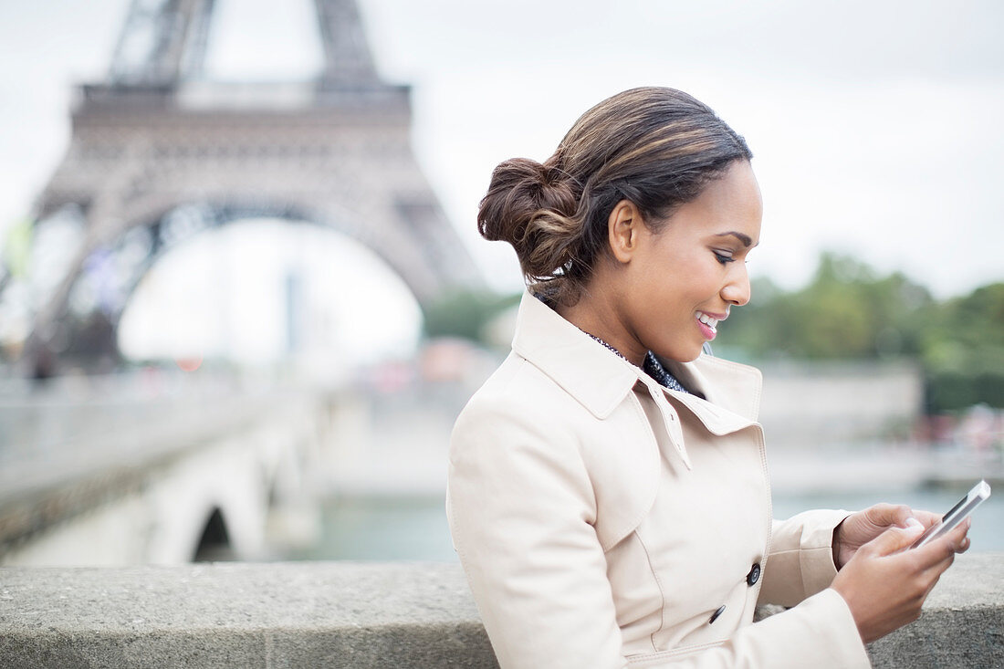 Businesswoman using cell phone in Paris