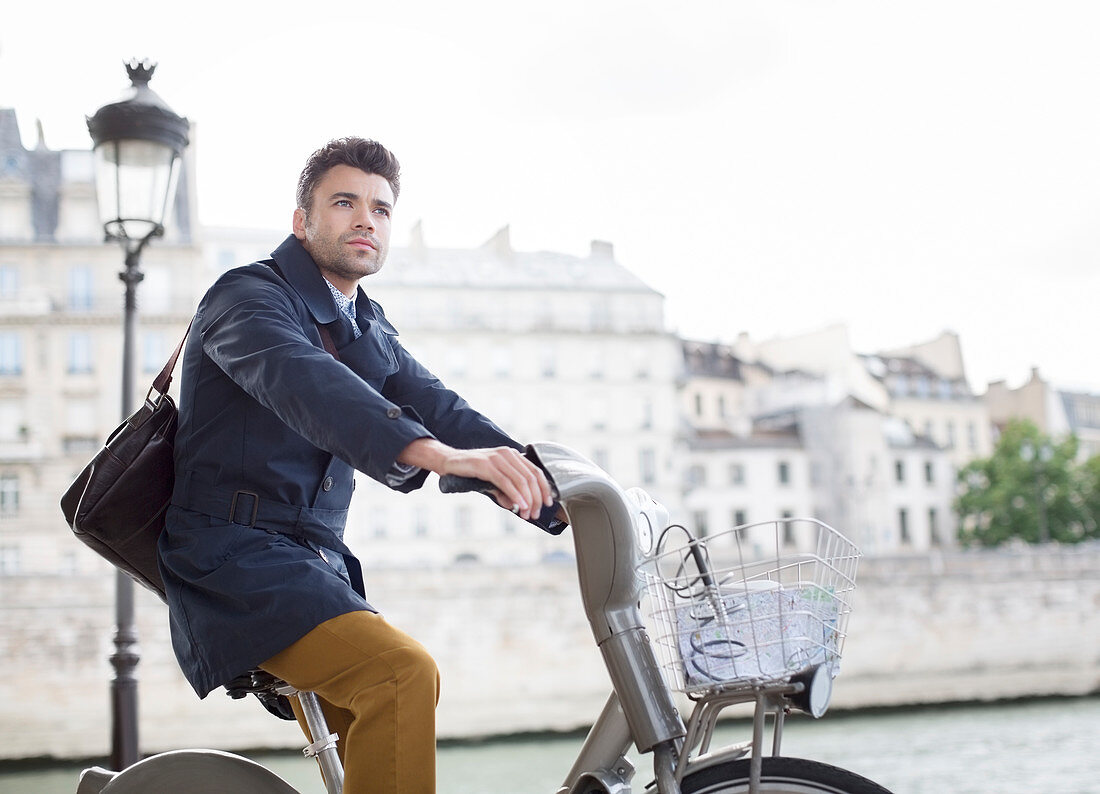 Businessman riding bicycle in Paris