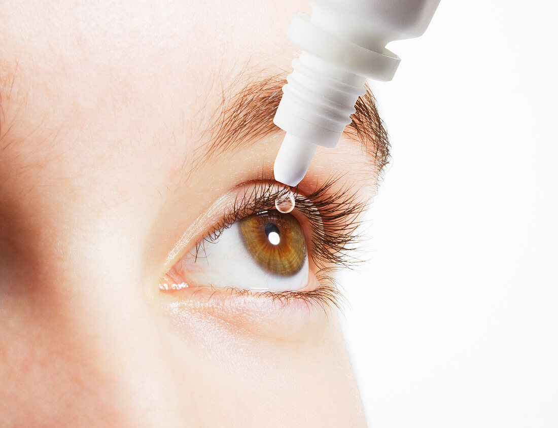 Woman inserting eye drops in eye