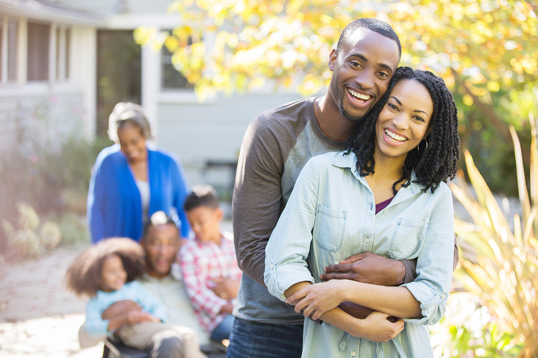 Portrait of happy couple hugging outdoors