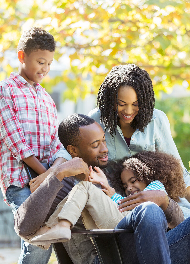 Happy family hugging outdoors