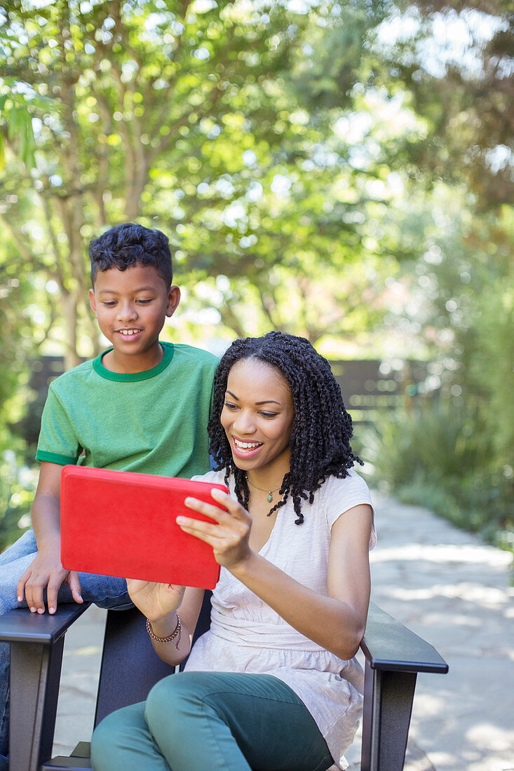 Mother and son using digital tablet