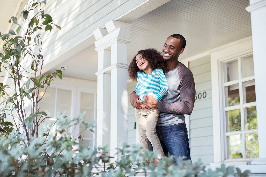 Happy father and daughter on porch