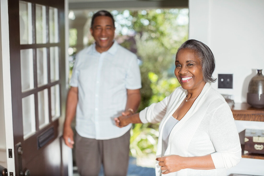 Smiling senior couple holding hands