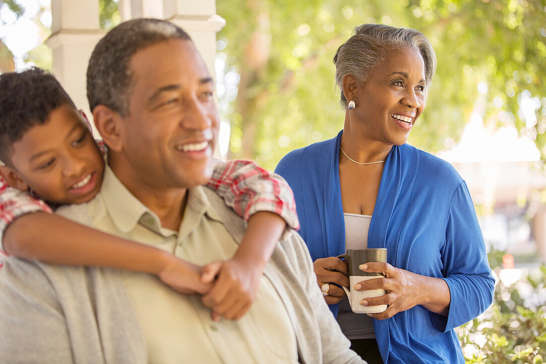 Happy grandparents and grandson on porch