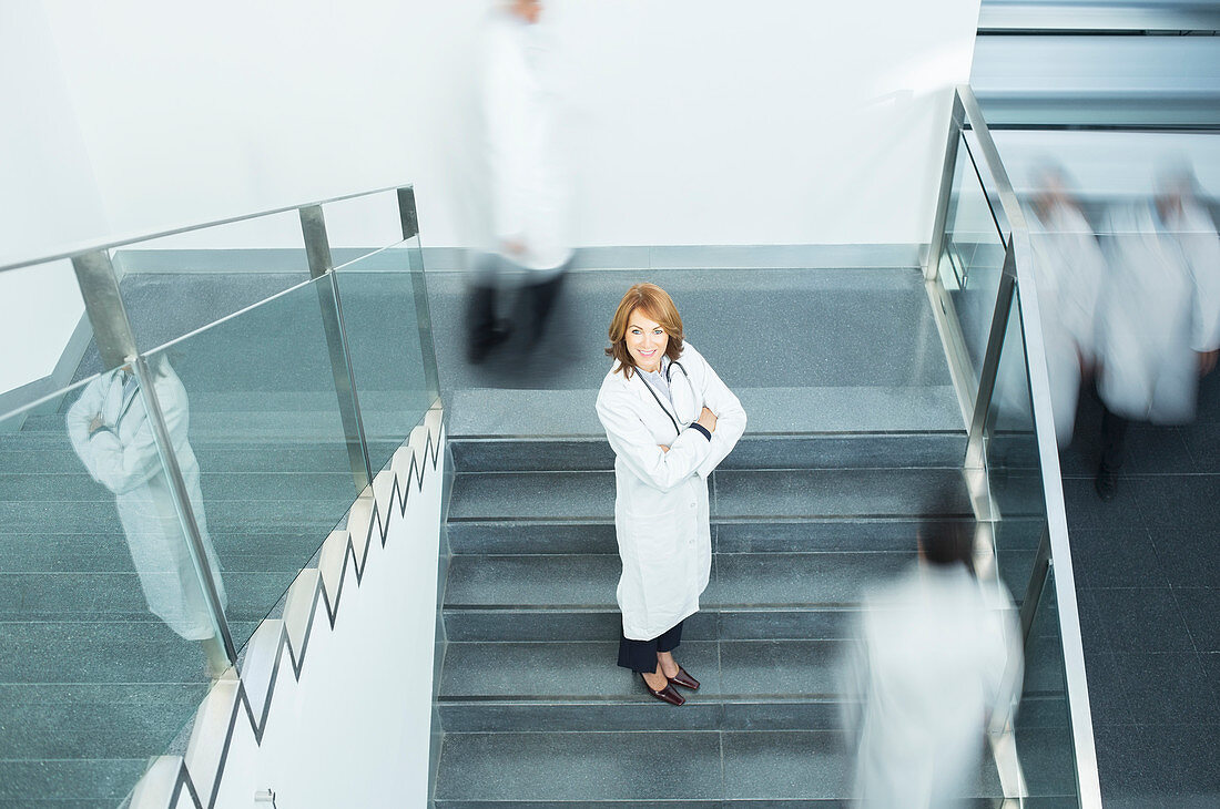 Portrait of confident doctor on staircase