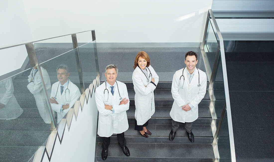 Portrait of confident doctors on stairs