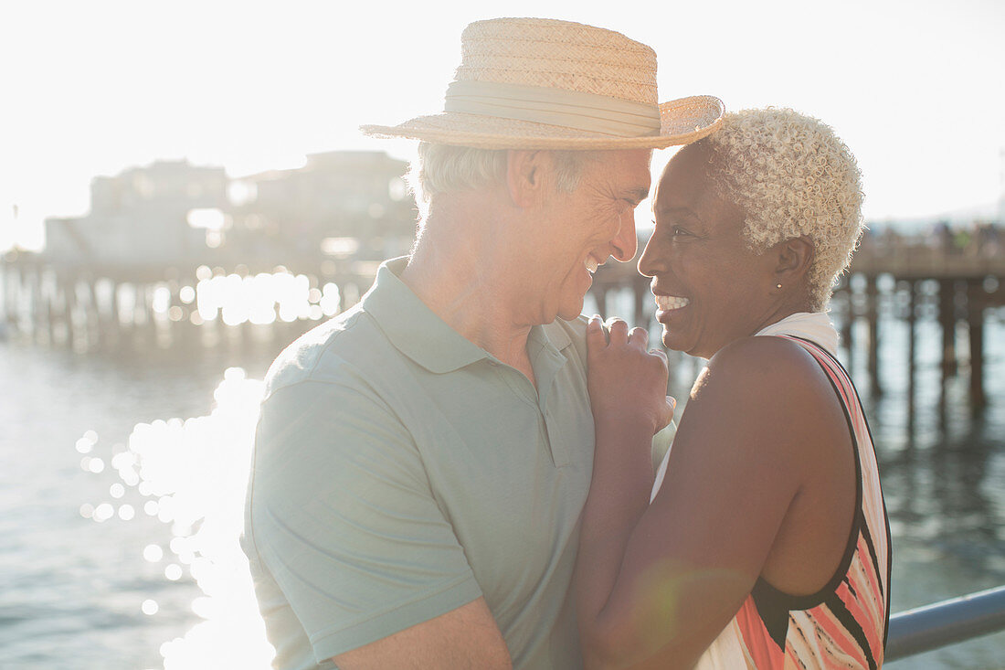 Senior couple hugging on pier