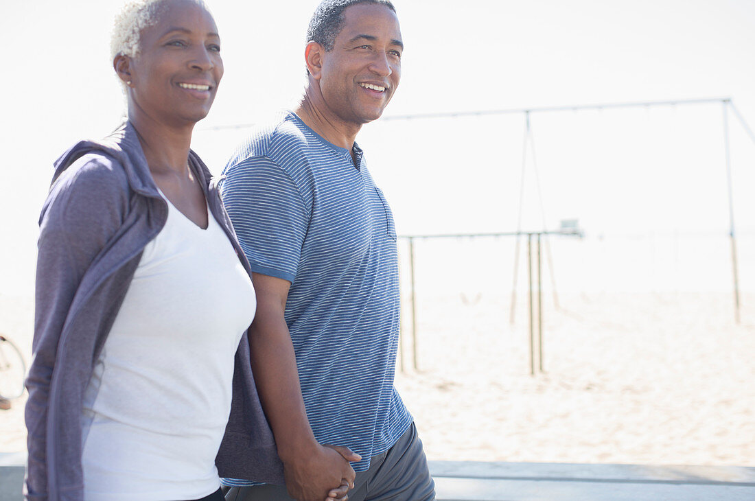 Senior couple holding hands and walking