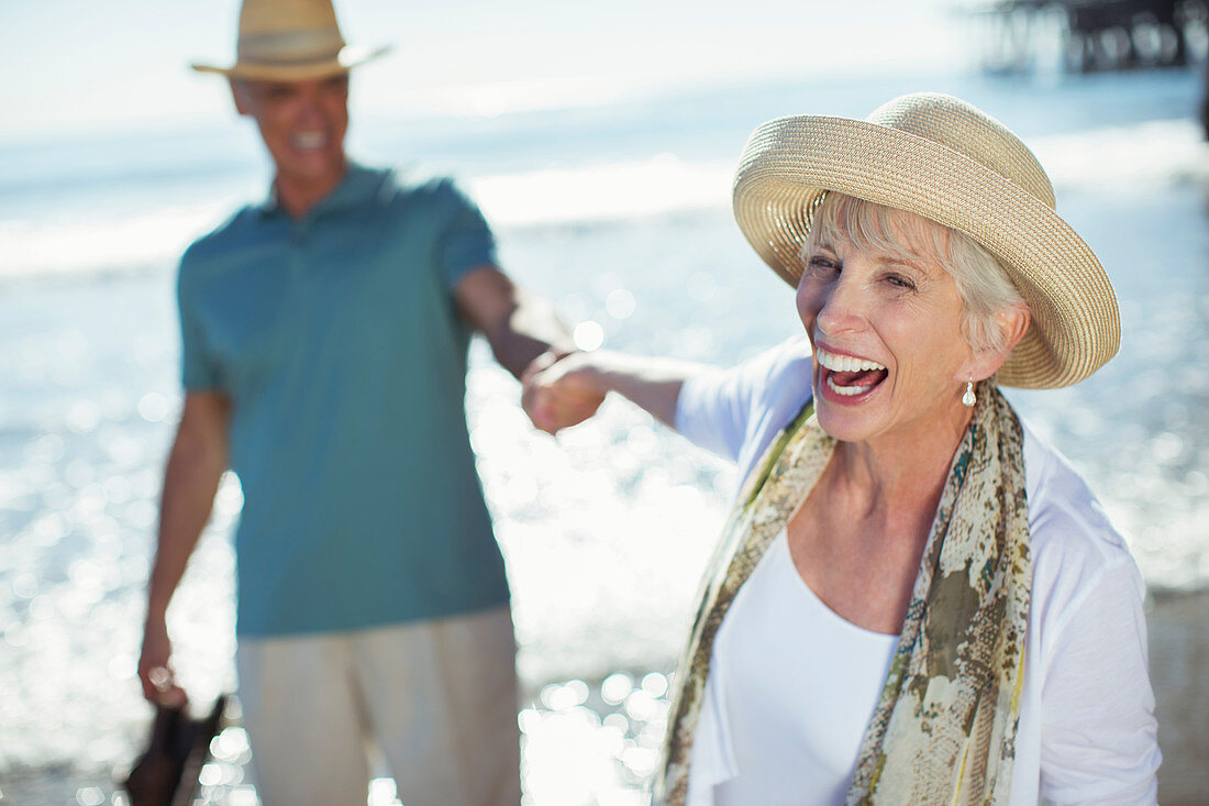 Enthusiastic senior couple holding hands