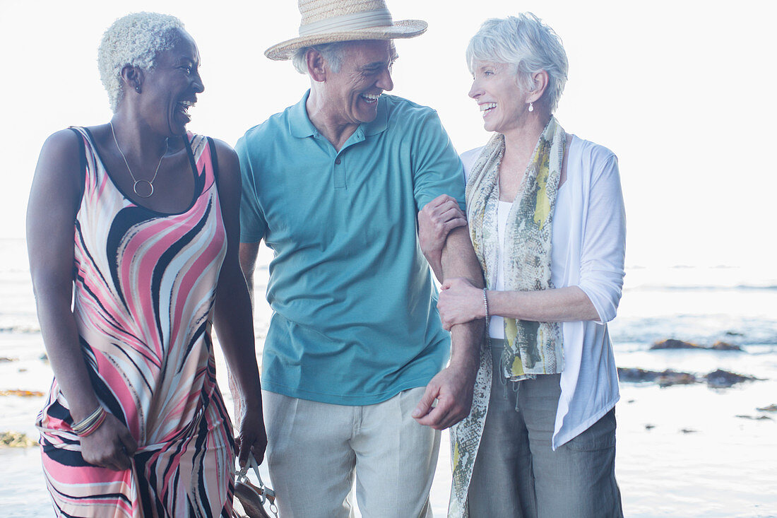 Senior friends walking on beach