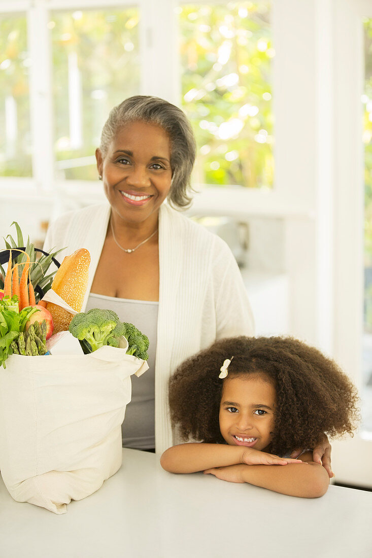 Grandmother and grandchild with groceries