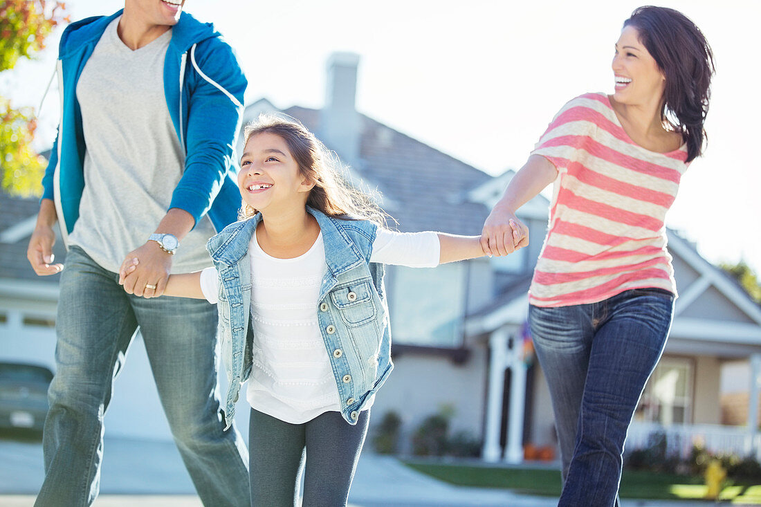 Happy family holding hands and running