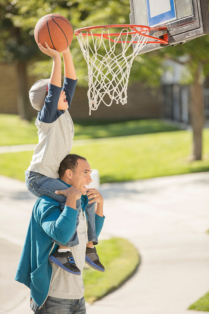 Father and son playing basketball