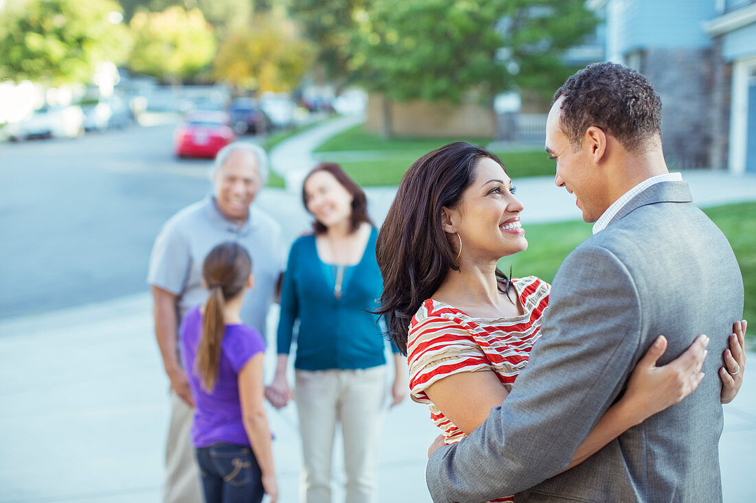 Couple hugging in driveway