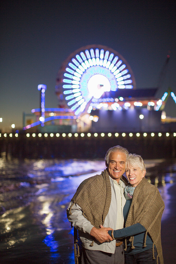 Senior couple on beach at night