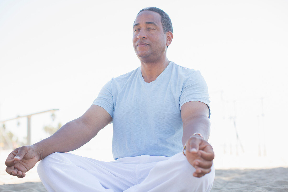 Serene senior man meditating