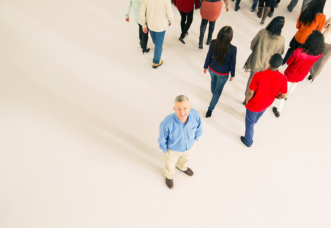 Crowd walking away from man