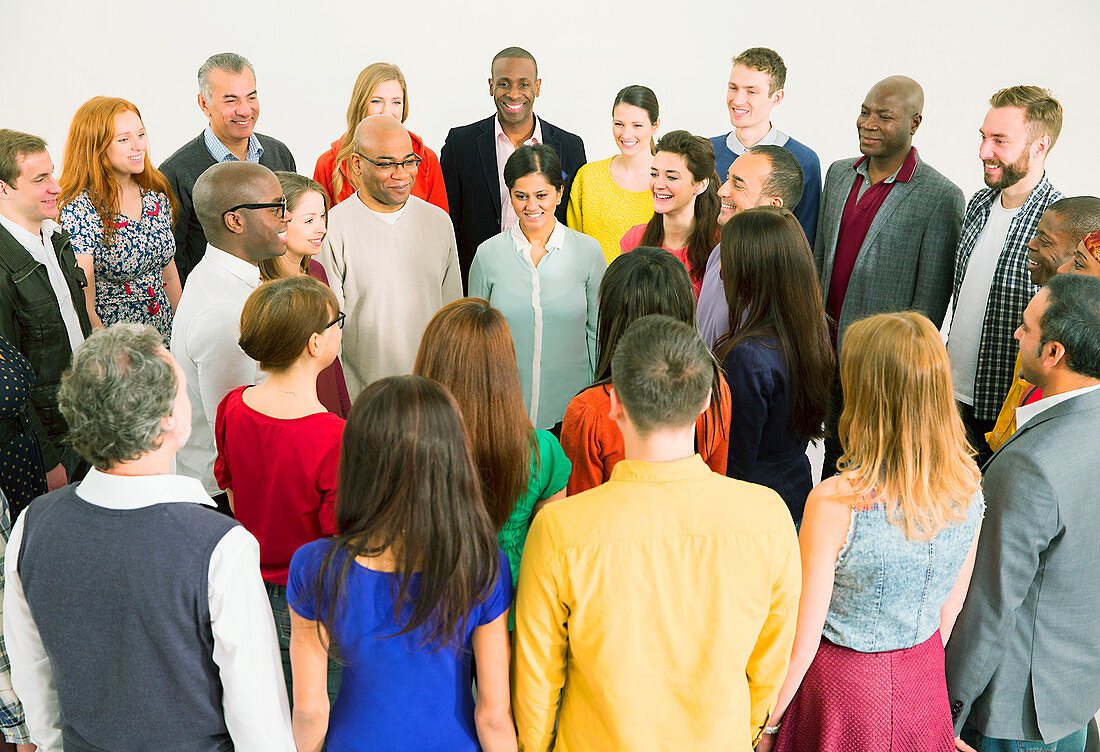 Diverse crowd meeting in circle