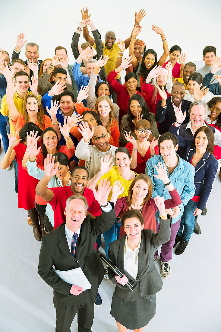 Portrait of diverse workers waving