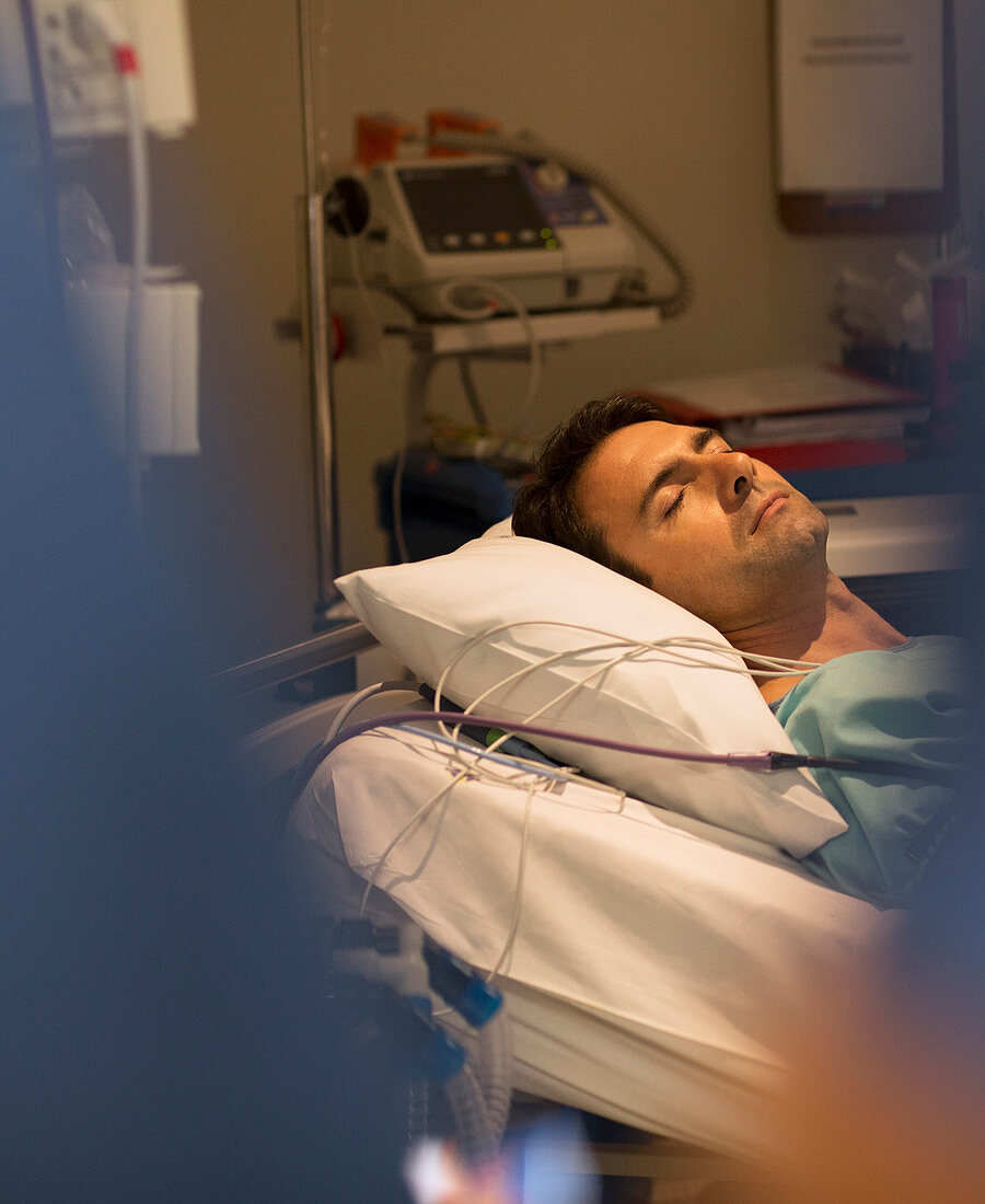 Male patient sleeping in hospital bed