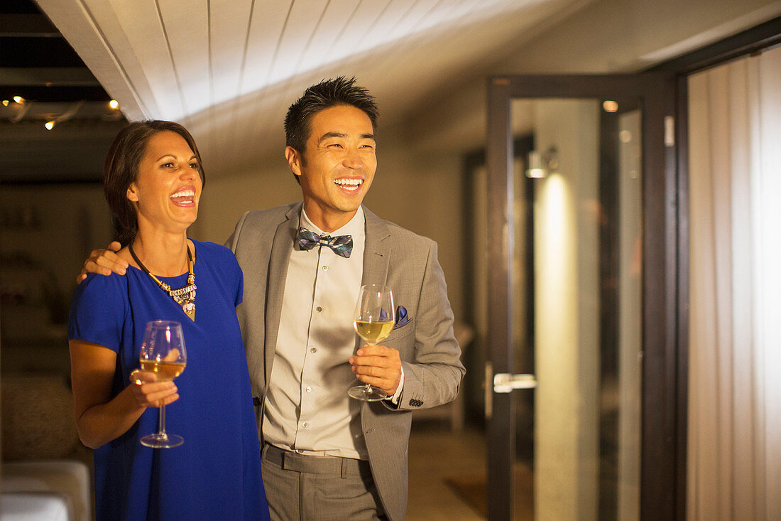 Couple laughing together at party