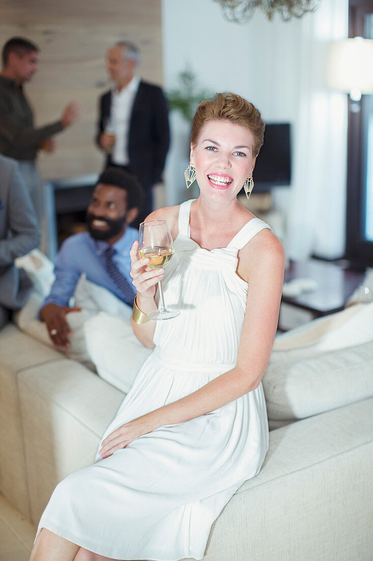 Woman smiling on sofa at party