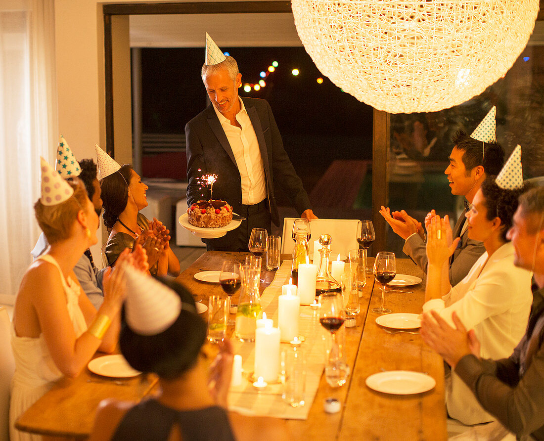 Man serving birthday cake at party