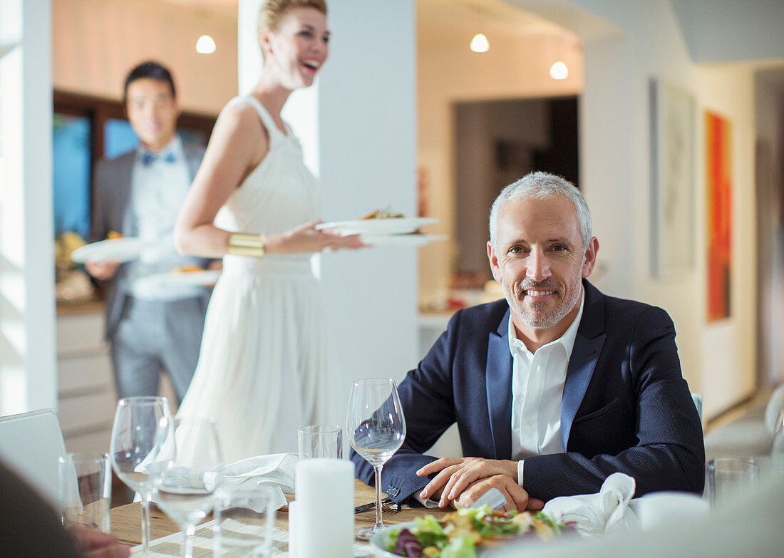 Man smiling at table at dinner party