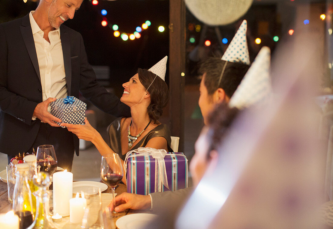 Man giving present at birthday party