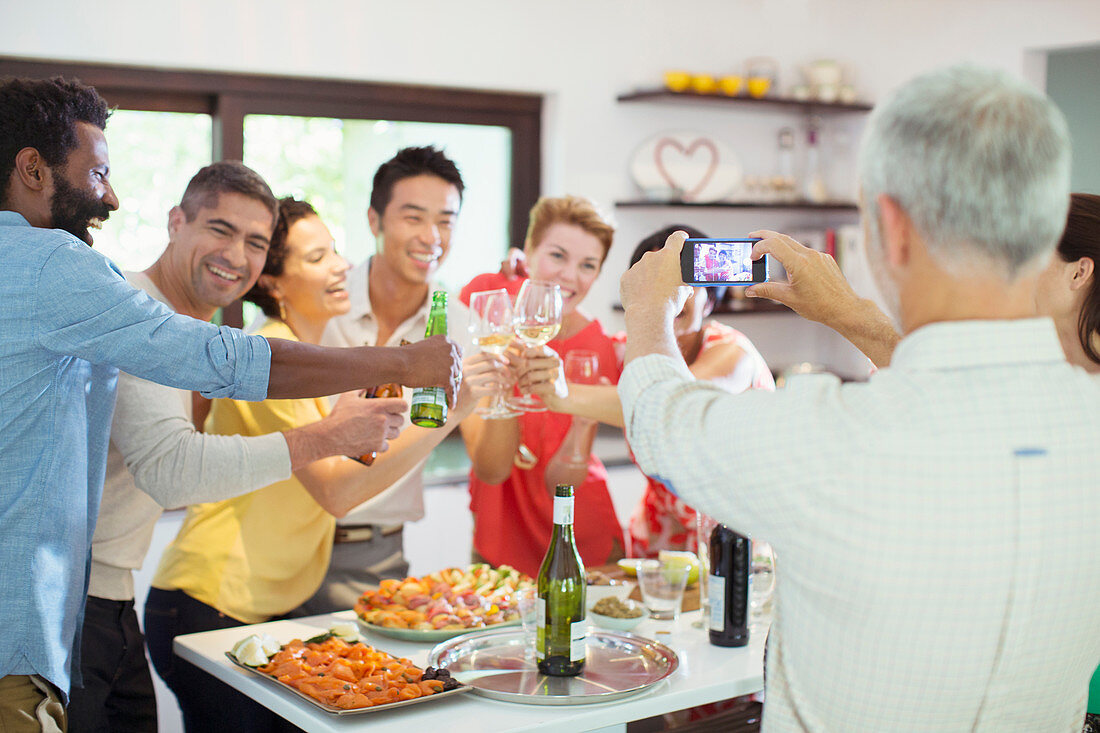 Man taking picture of friends at party