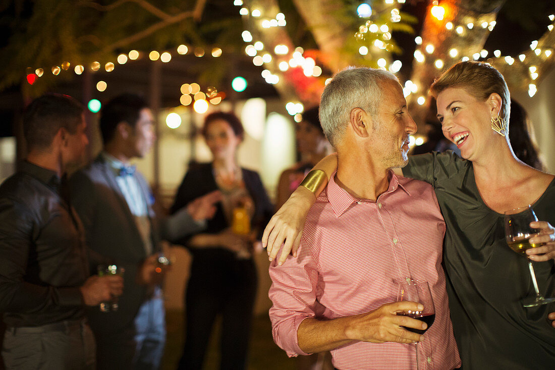 Couple hugging at party