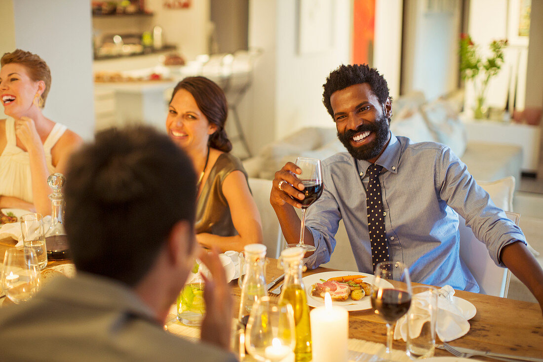 Friends talking at dinner party