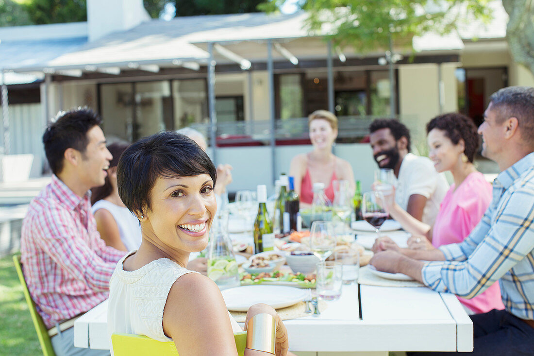 Woman smiling at table outdoors