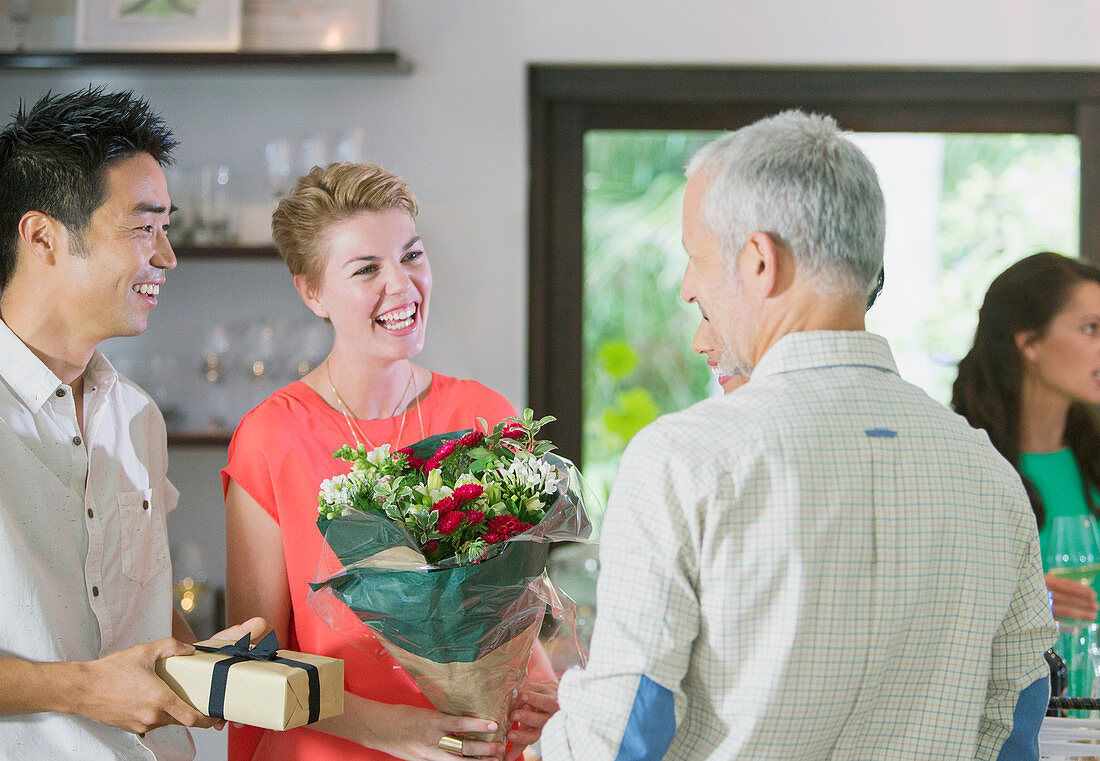 Friends exchanging gifts at party