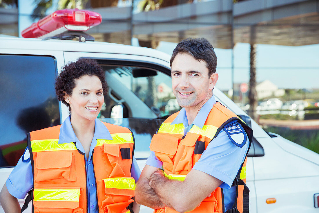 Paramedics smiling outside ambulance
