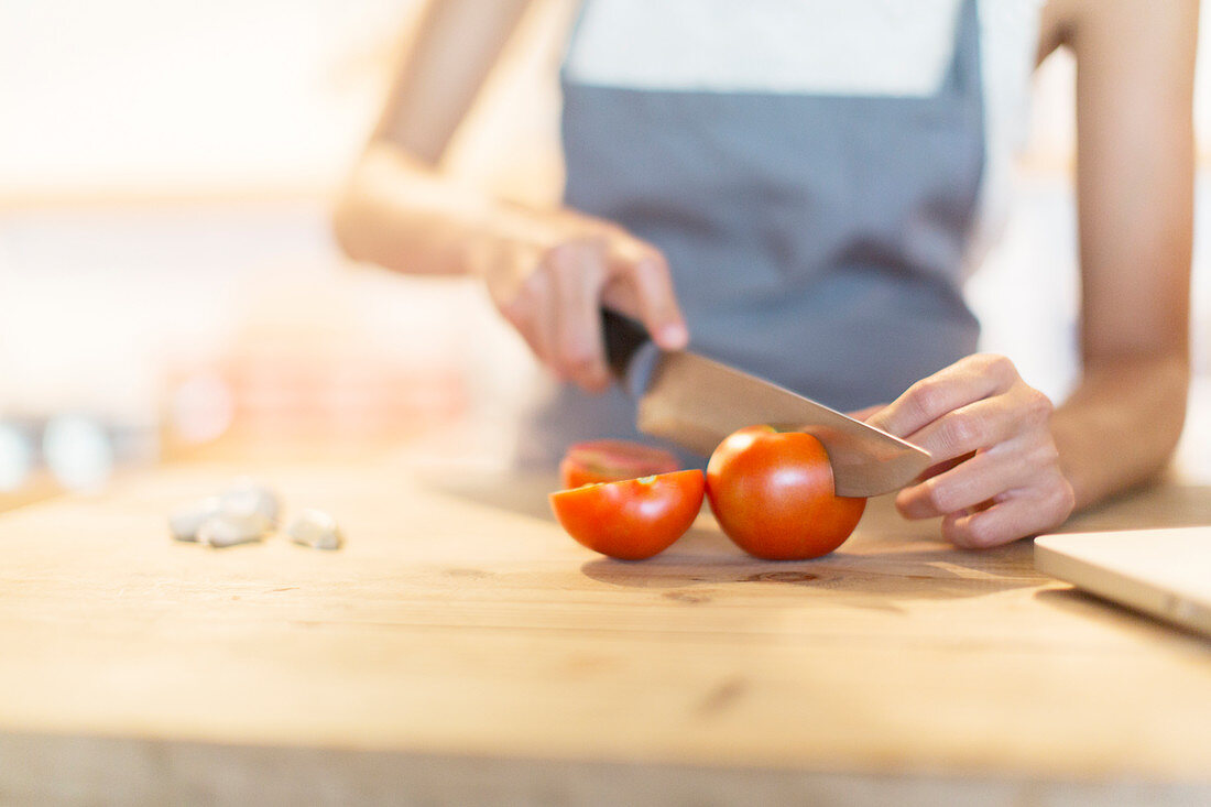 Woman chopping vegetables in kitchen