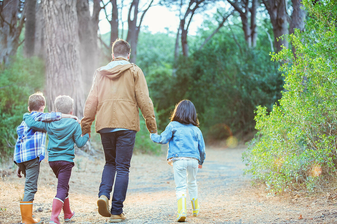 Students and teacher walking in forest