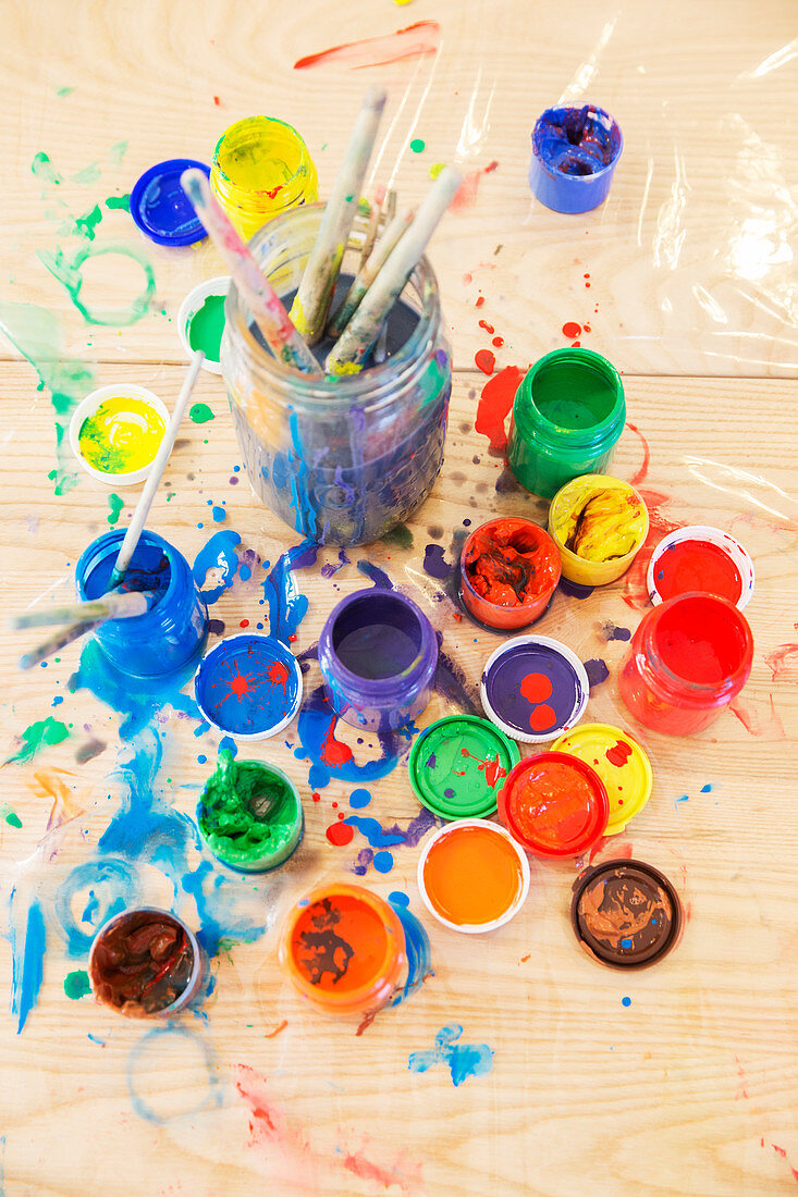 Jars of paint and paintbrushes
