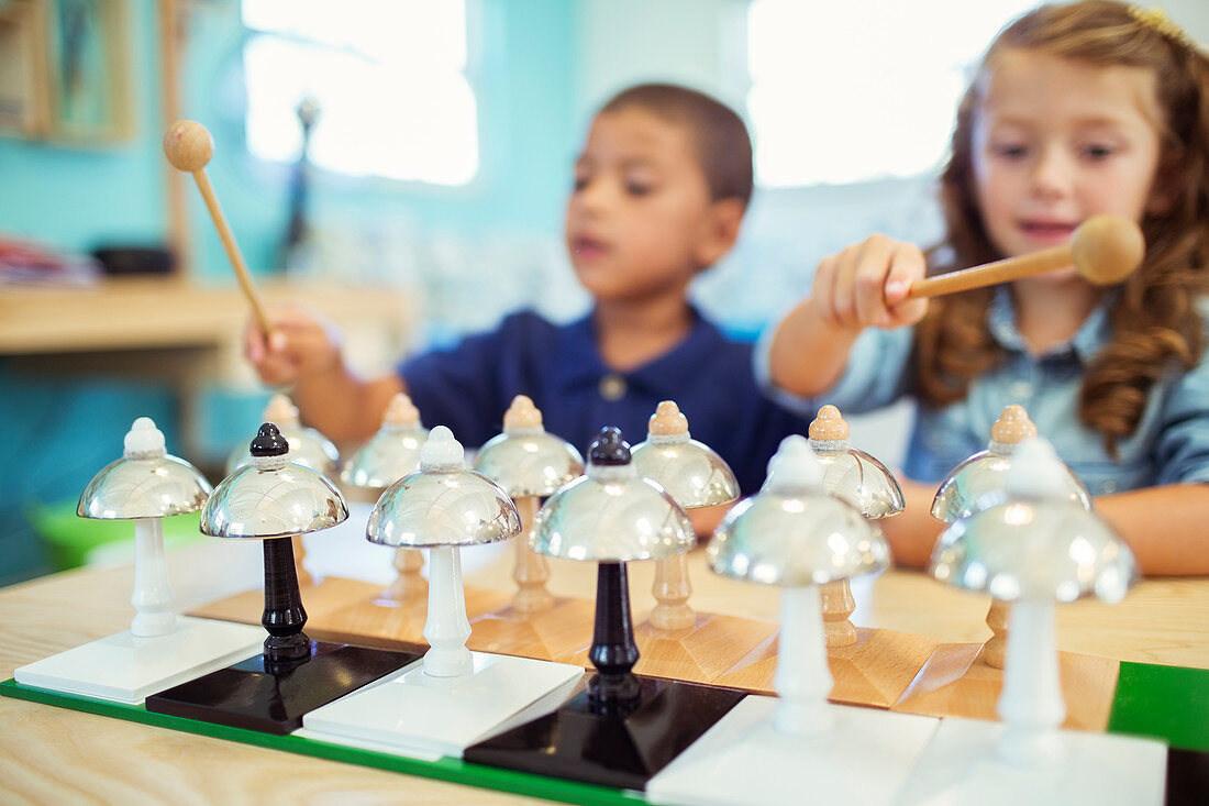 Students playing bells in class