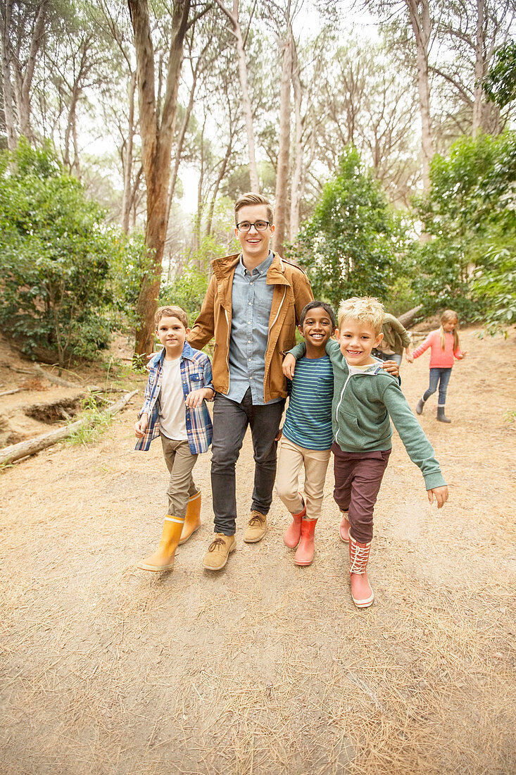 Students and teacher walking in forest