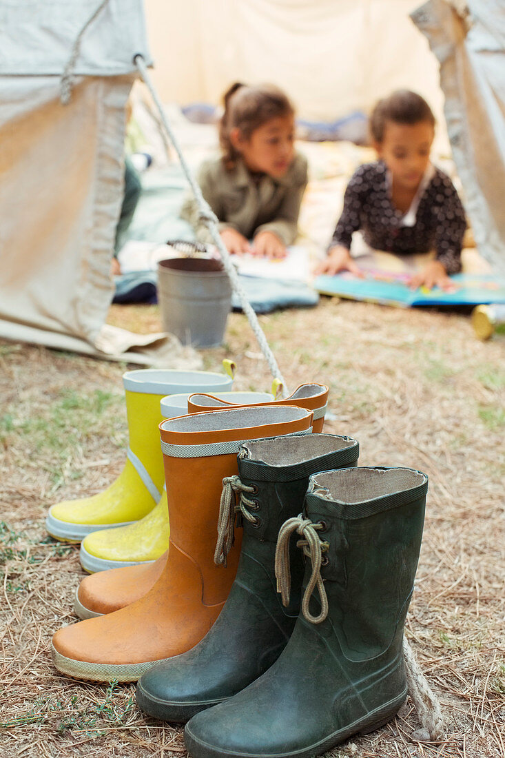 Rain boots lined up outside tent