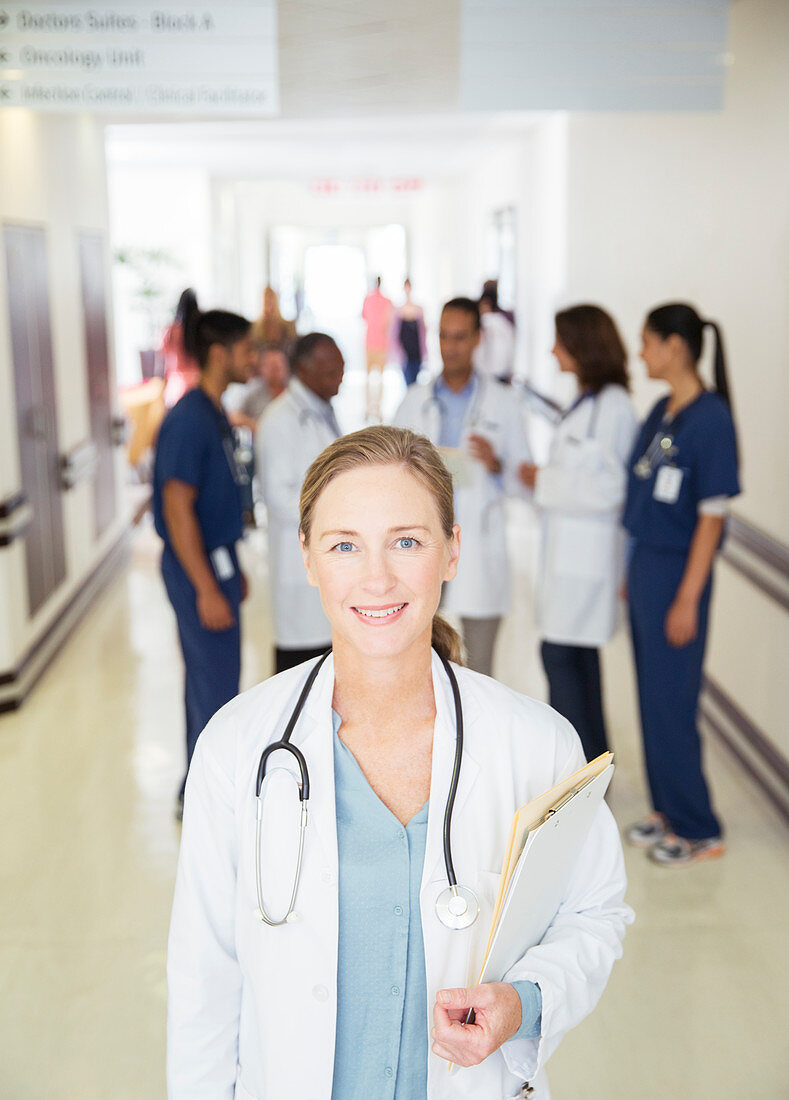 Doctor smiling in hospital hallway