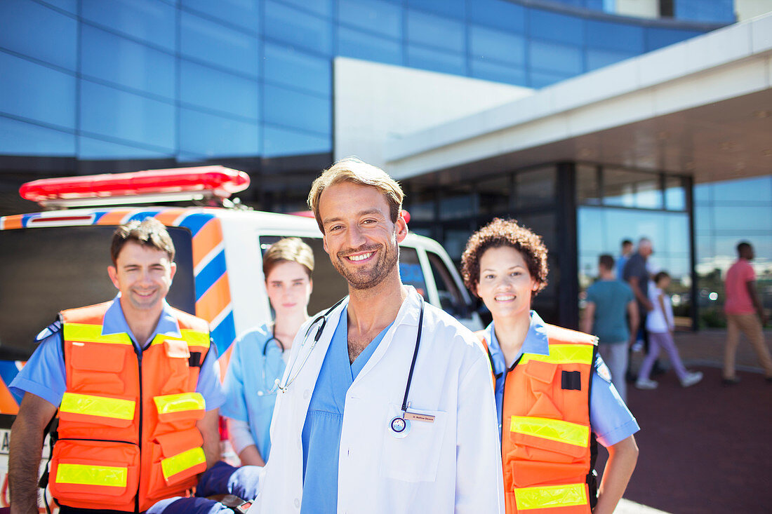 Doctor smiling with paramedics