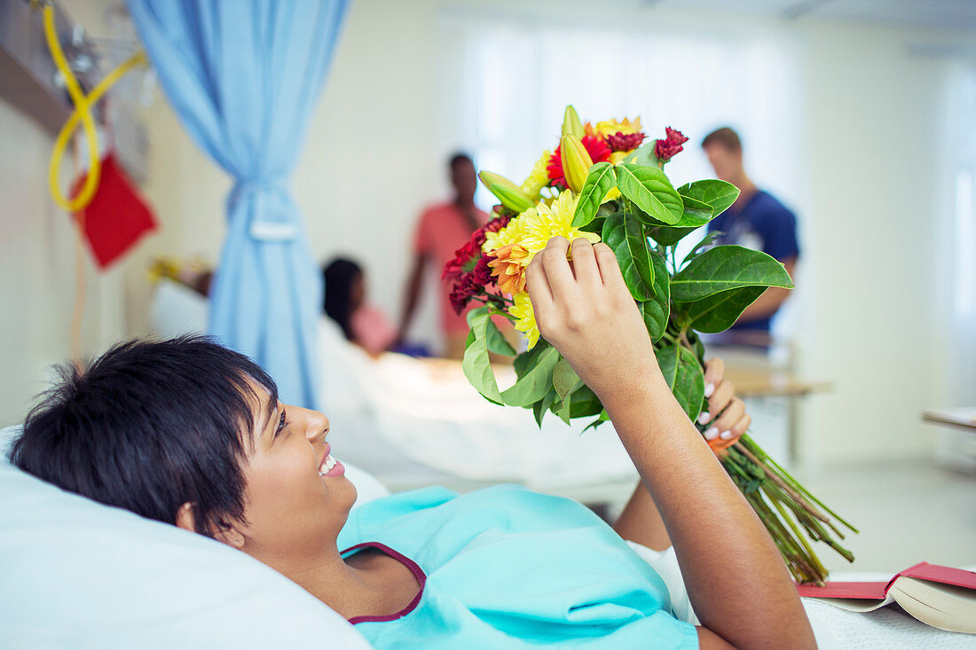 Patient admiring bouquet of flowers room